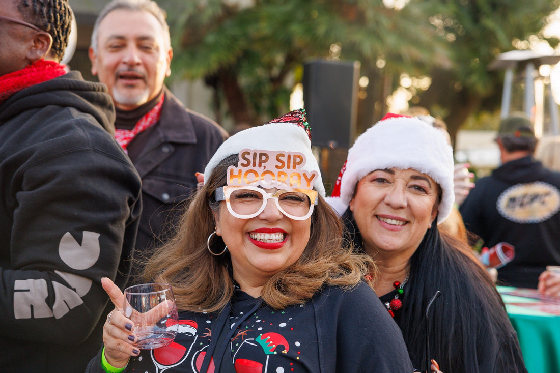 Festive visitors wearing Santa hats at the Ventura Winter Wine Walk